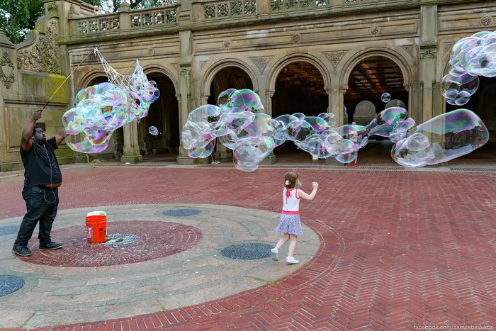 A photo of a little girl chasing bubbles in Central Park